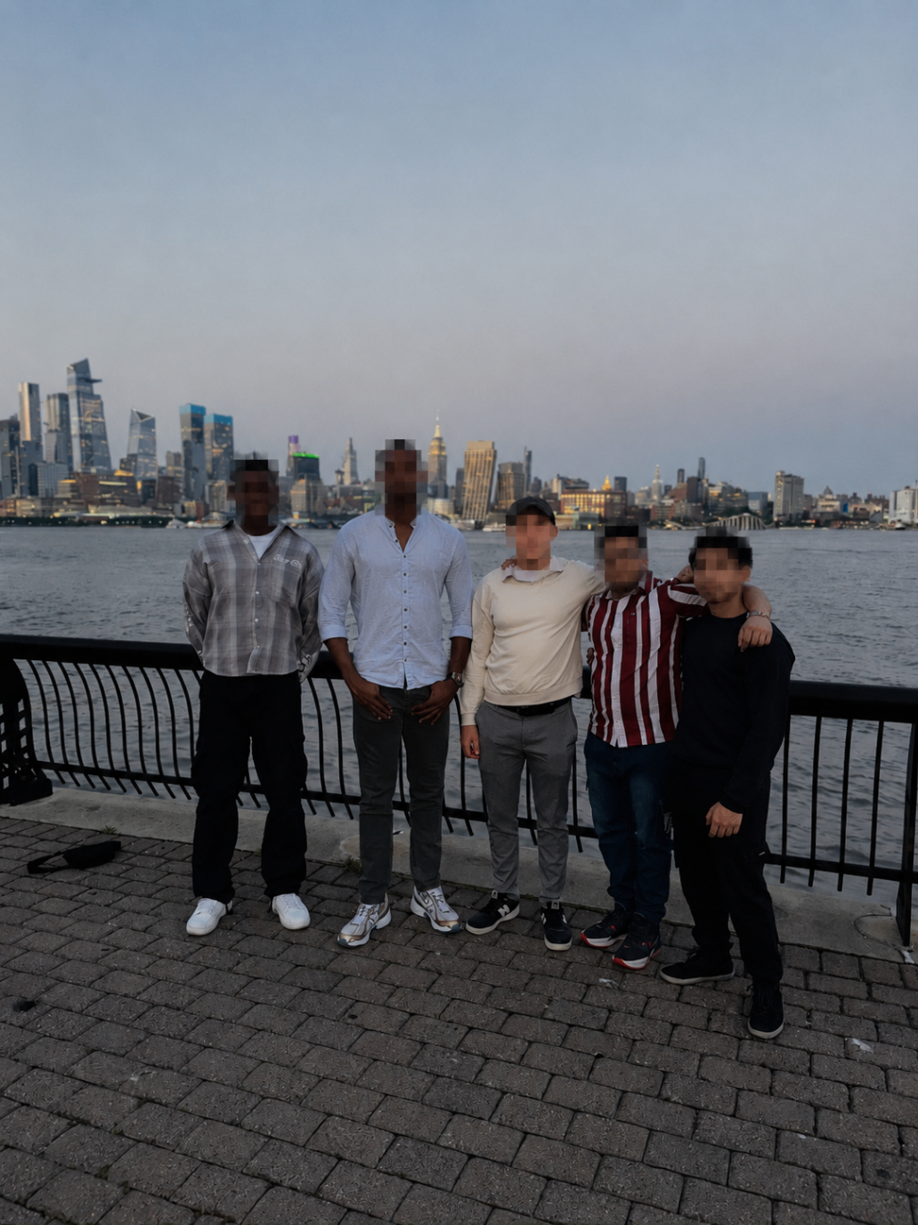 Brotherhood meetup by the waterfront with the skyline behind them