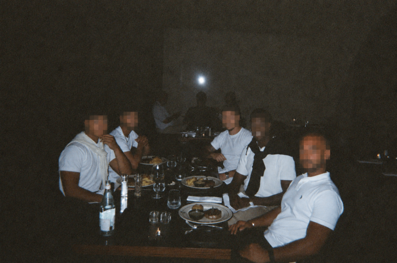 Brotherhood meetup seated around a dark restaurant table