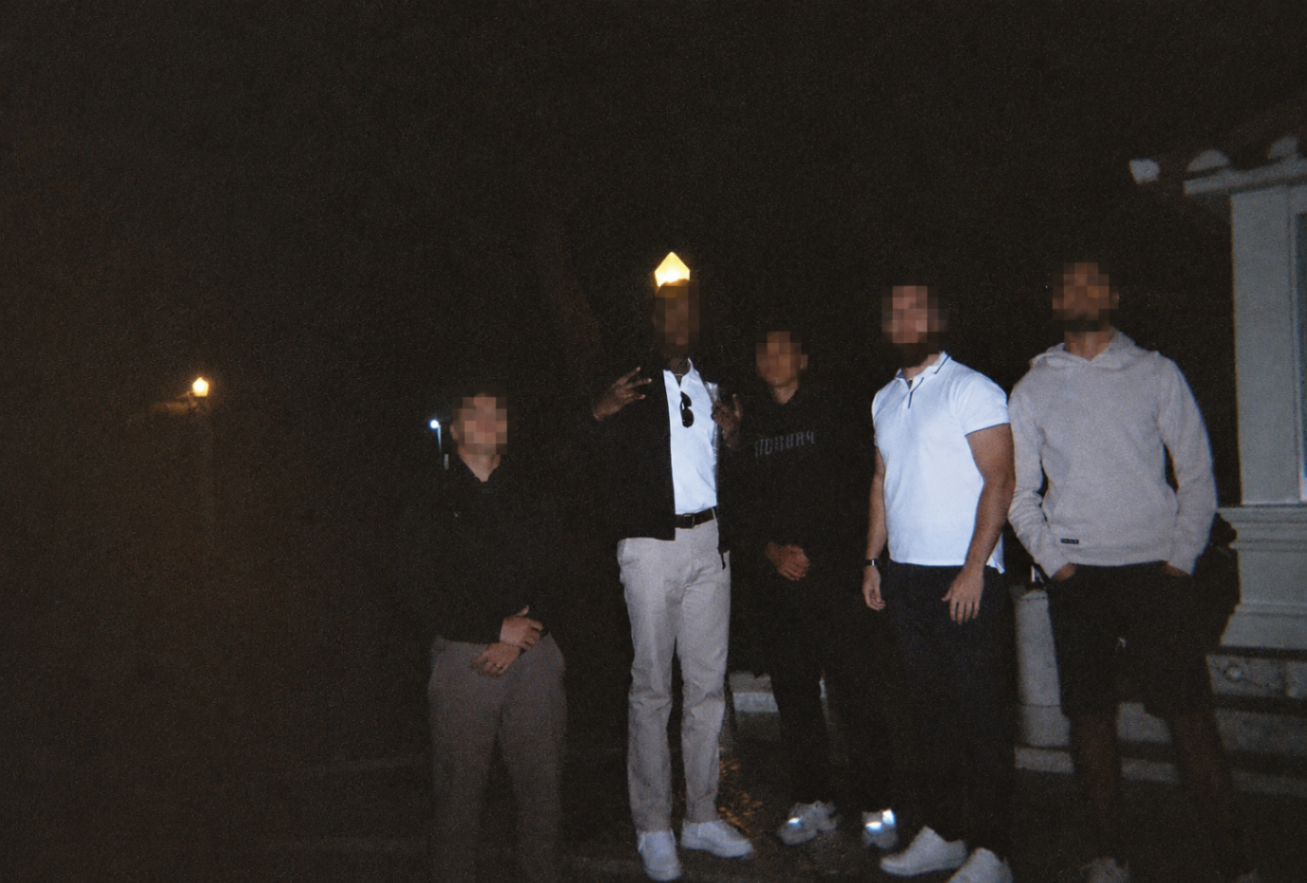Brotherhood meetup standing together outdoors at night