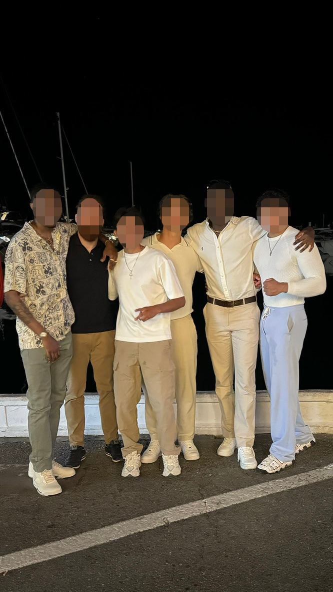 Brotherhood meetup posing together by the marina at night