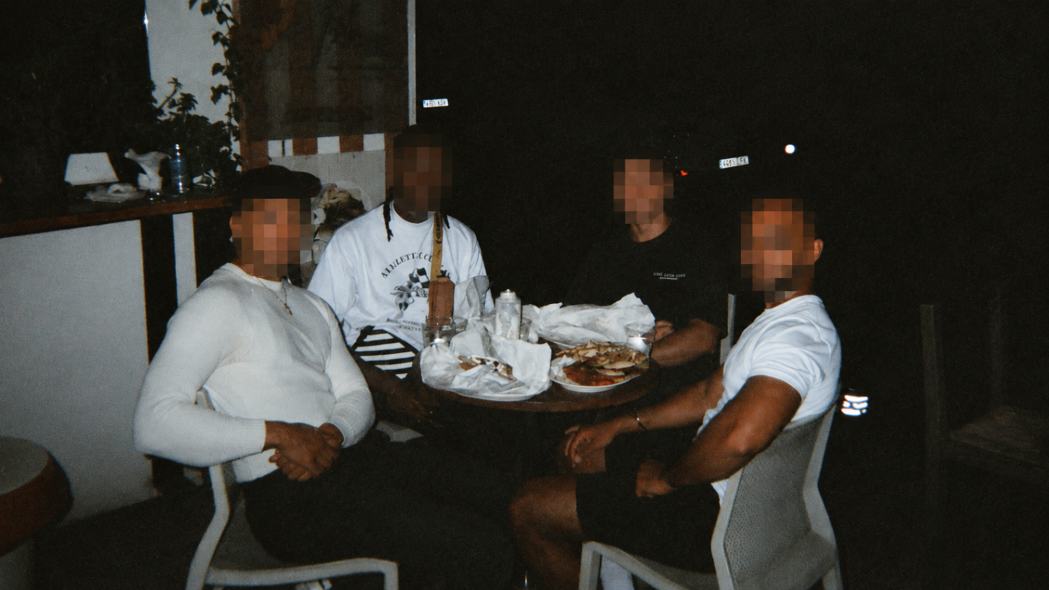 Brotherhood meetup sharing food around a table at night