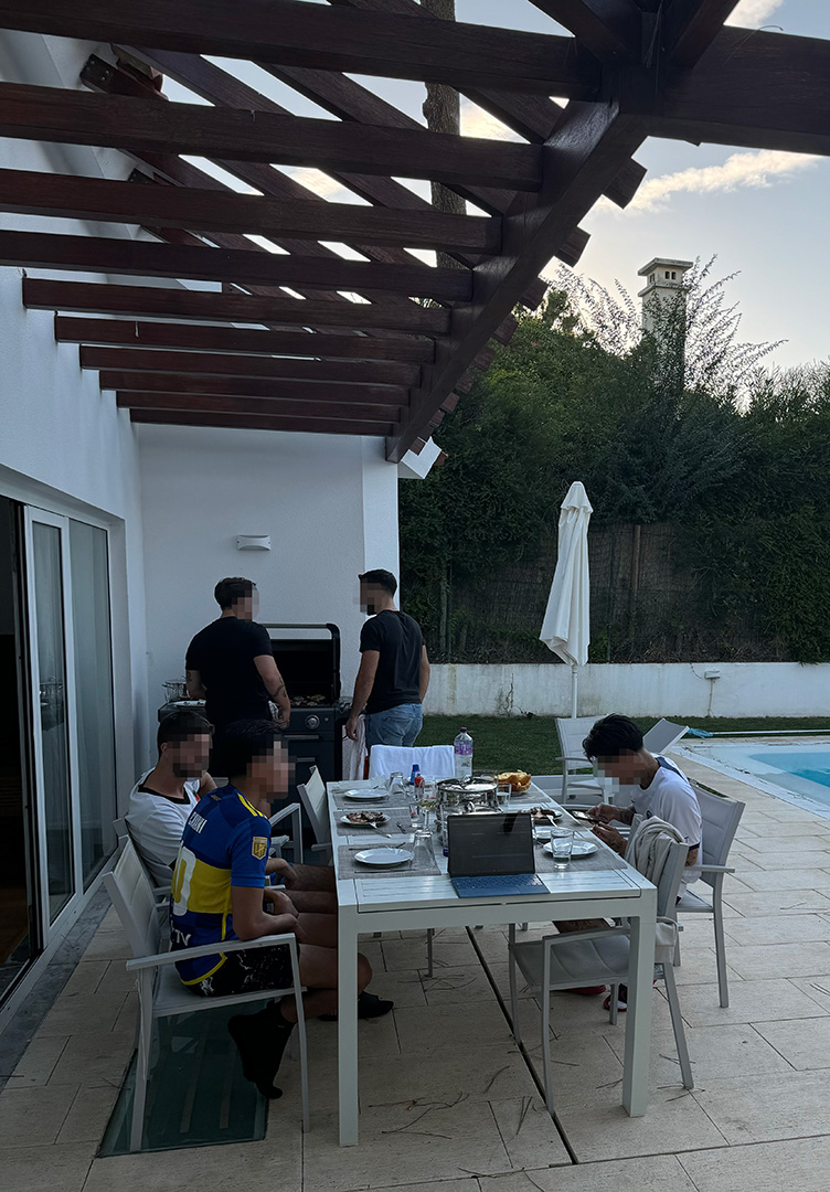 Brotherhood meetup sharing a meal beside the pool