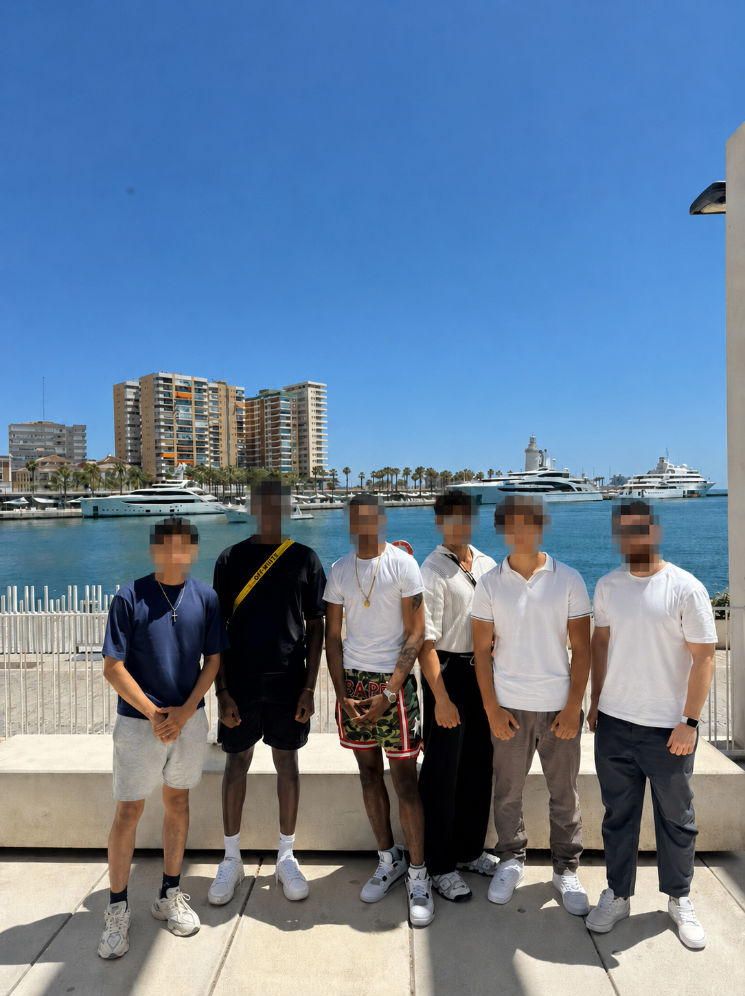 Brotherhood meetup posing together at a marina in daylight